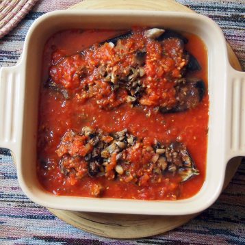 spoon the tomato sauce over and around the stuffed aubergines